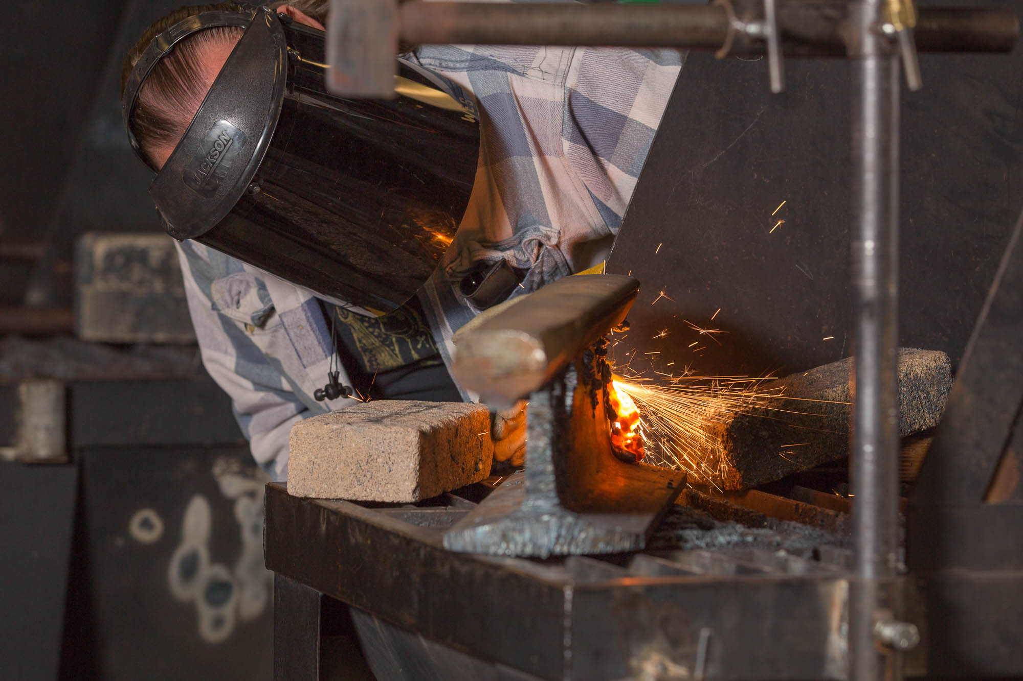 Welding student cutting metal in a shop